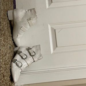 White boots with outline of silver